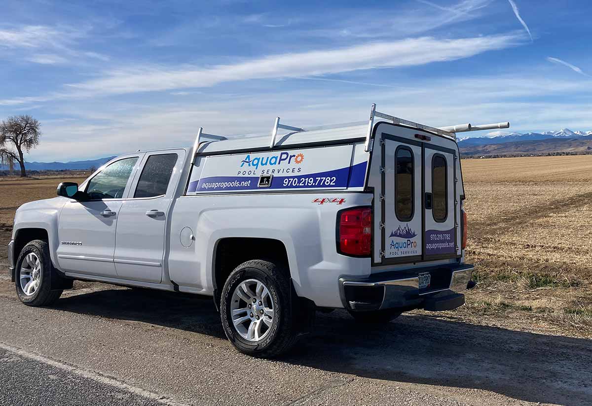 White Truck with Aqua Pro Services Logo, Colorado Mountains